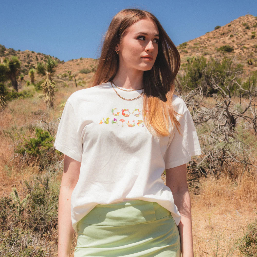 A woman in the desert wearing a Coney Island Picnic t-shirt.