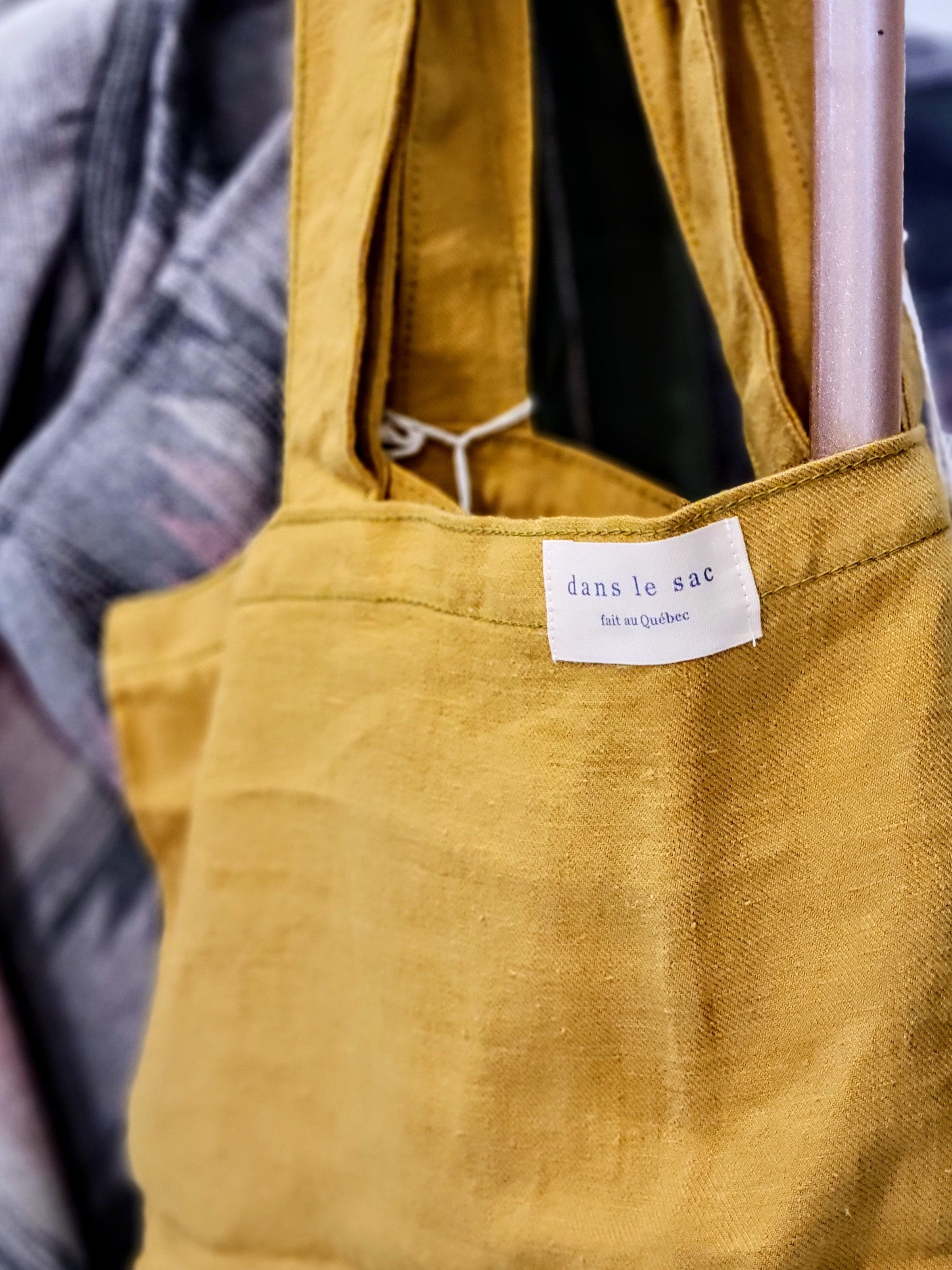 Up close image of a yellow Dans le Sac tote.