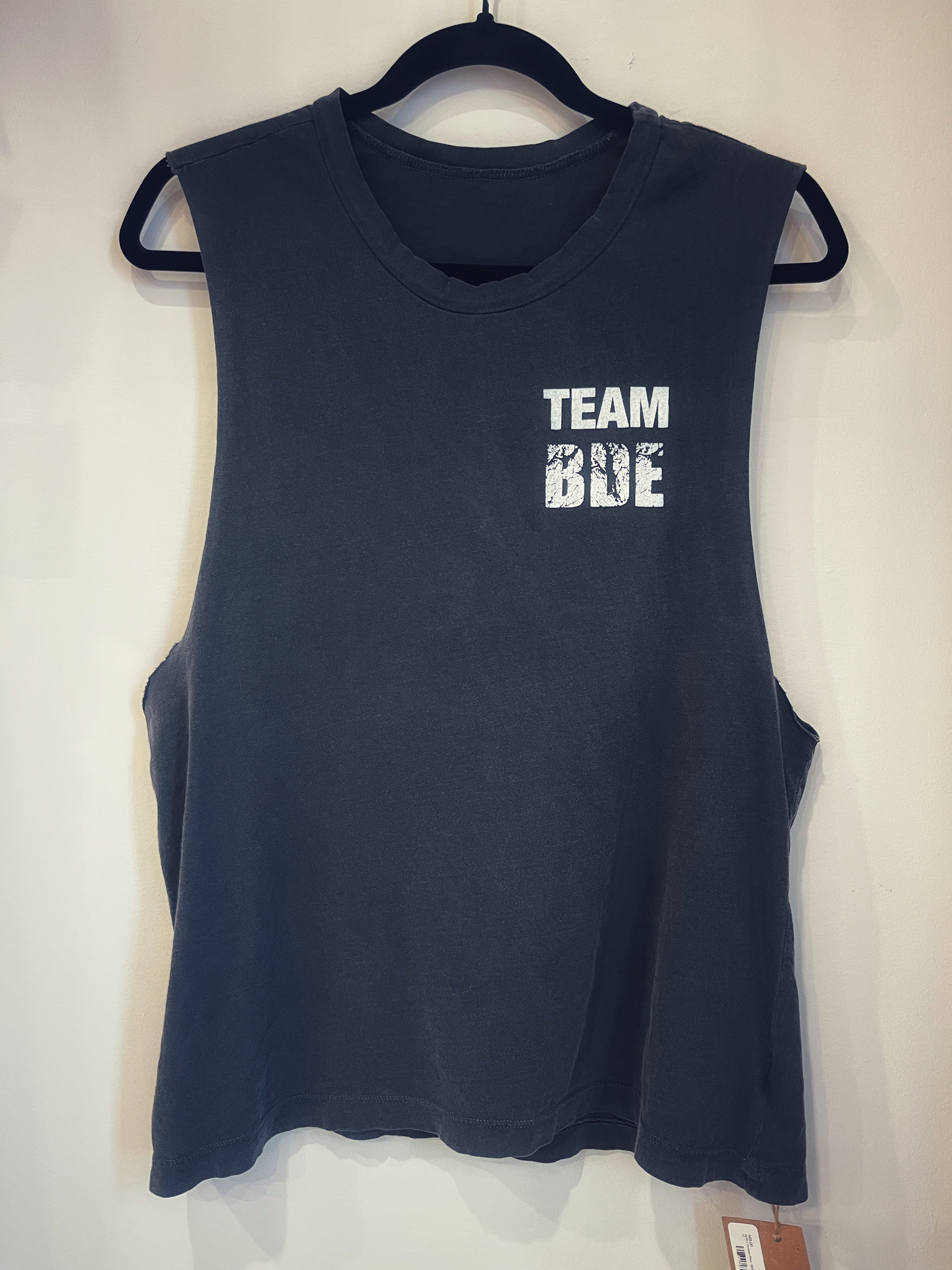 A black tank top with the phrase "Team BDE" in white over the left chest.